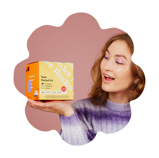 teen holding period kit box and looking shocked and happy